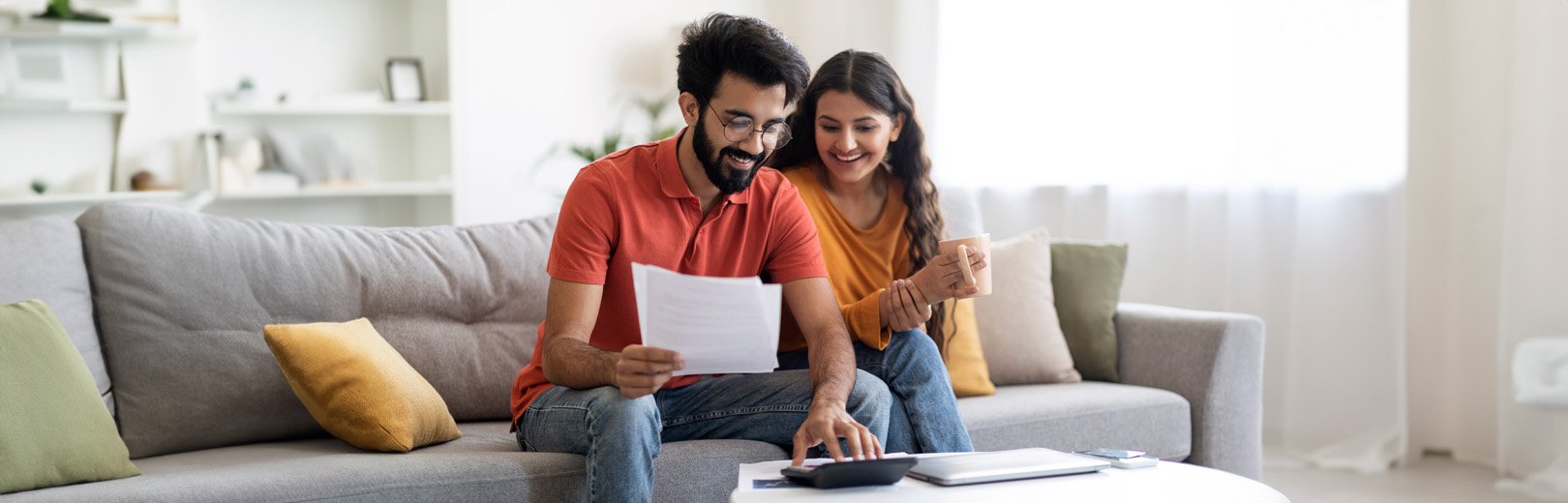 Couple on sofa with calculator