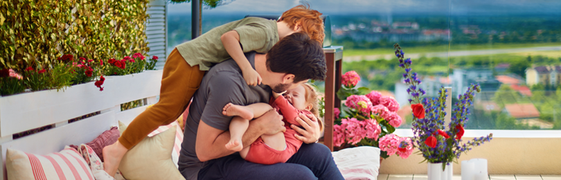 A father plays with his children on his new deck