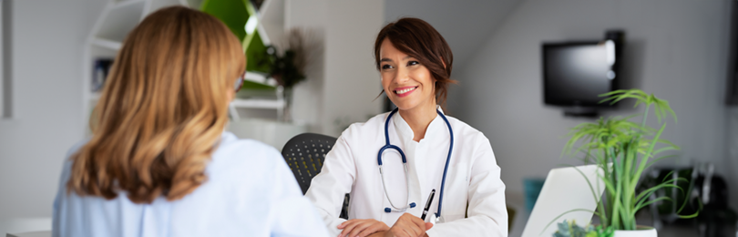 A doctor smiles at her patient